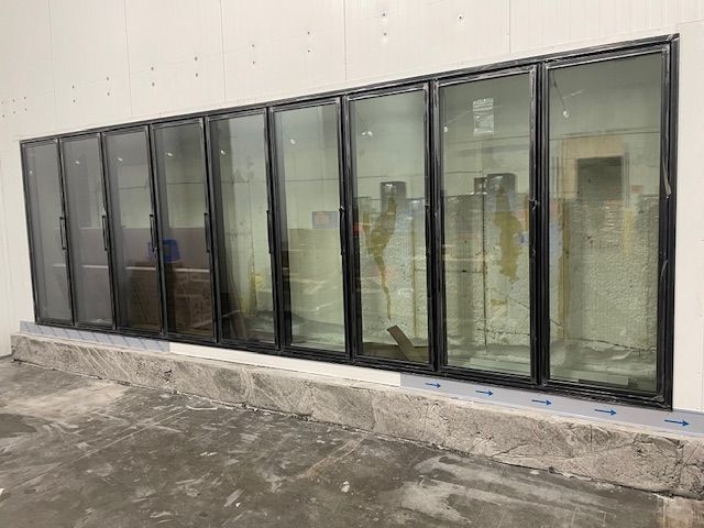 Cold storage room with metal shelving, temperature gauge at -14 degrees, and a large white tub.
