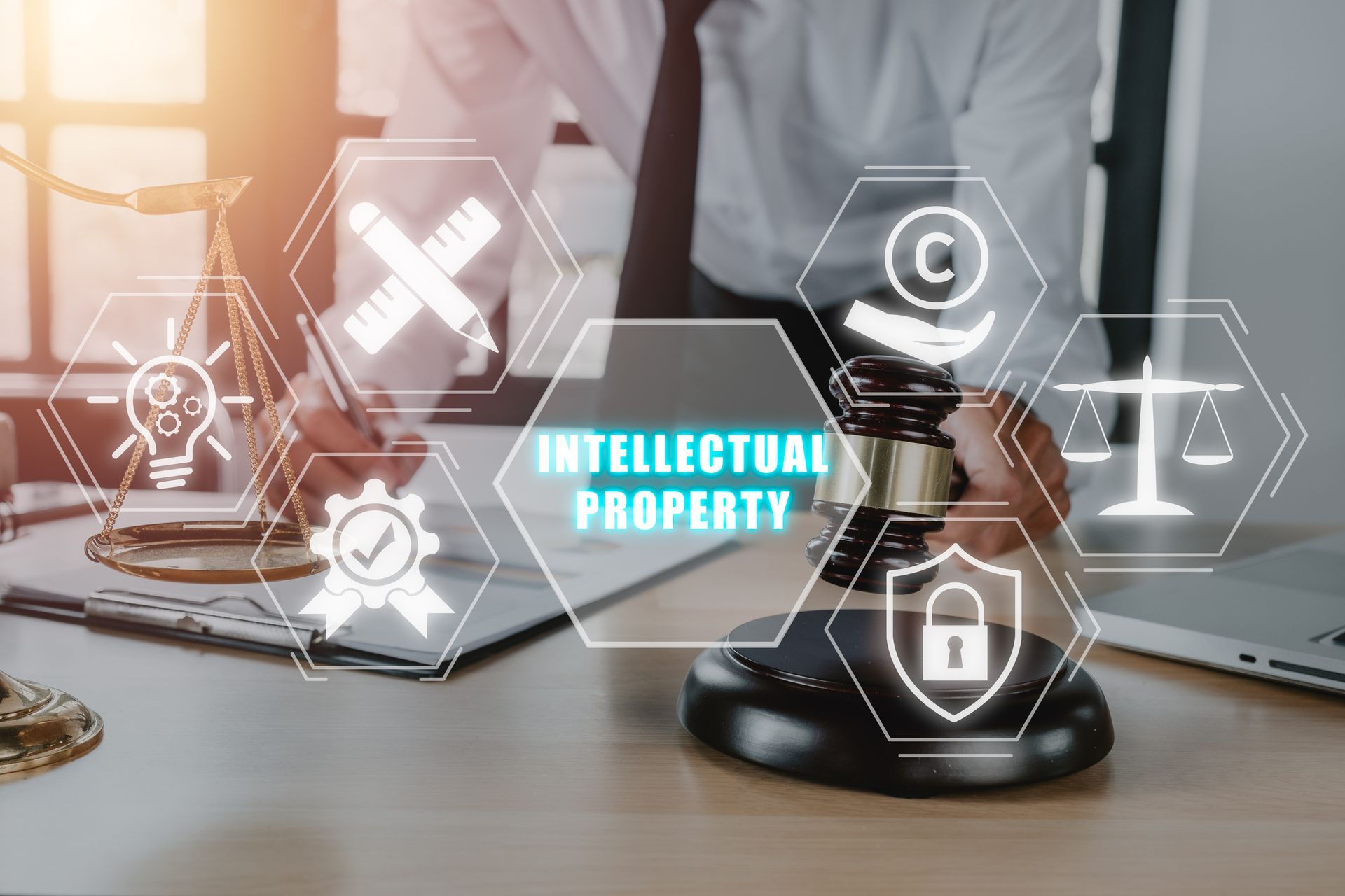 A man is holding a gavel in front of a computer screen that says `` intellectual property ''.