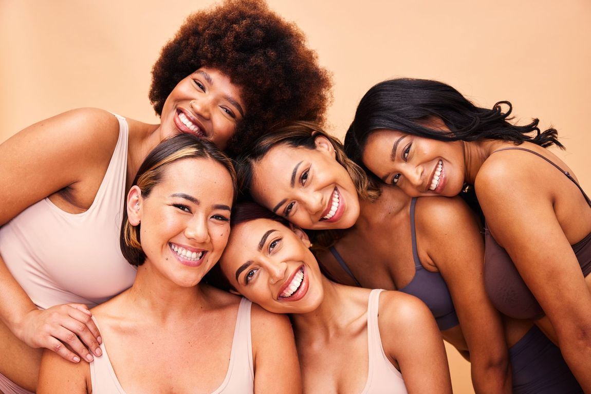 A group of women in underwear are posing for a picture together.