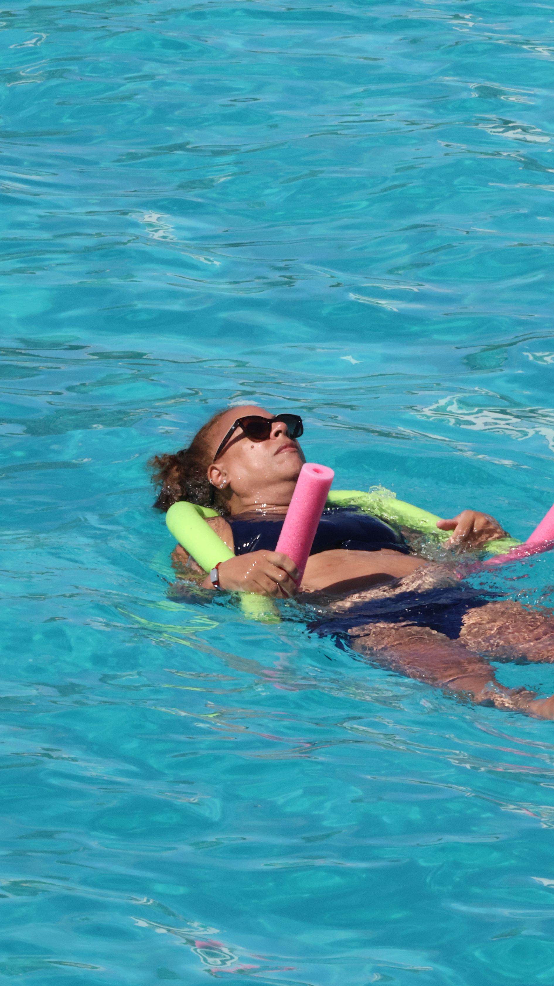 Woman relaxing at Mullet Bay on Sail The Phoenix