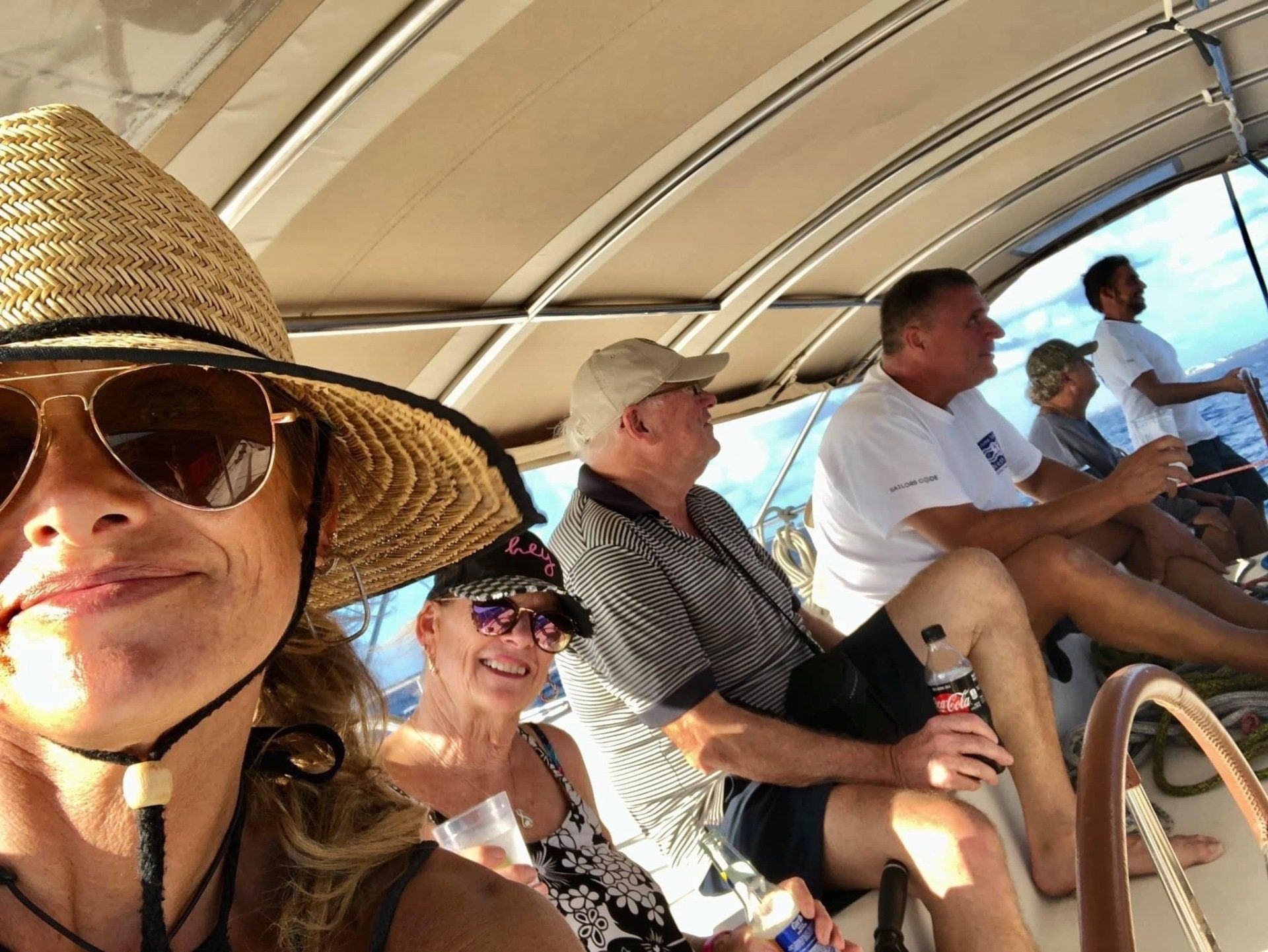 Guest taking selfie with Captain at the helm on the flybridge of Sail The Phoenix