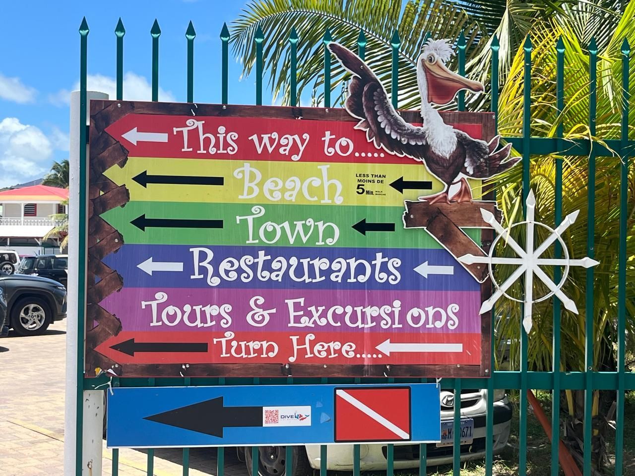Multi‑colored directional signs reading ‘Tours & Excursions’ with arrows pointing the way