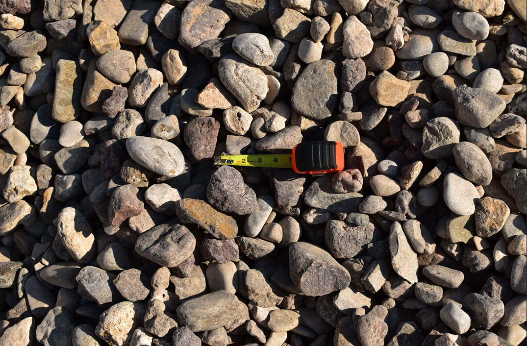 A pile of river rock is sitting on the ground.