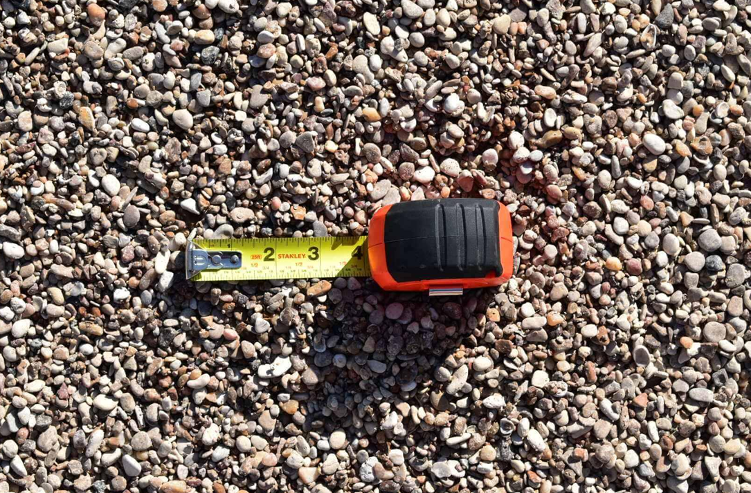 A pile of gravel is sitting on the ground.