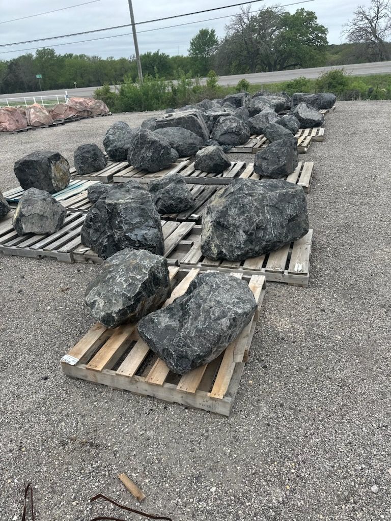 A pile of rocks sitting on top of wooden pallets.