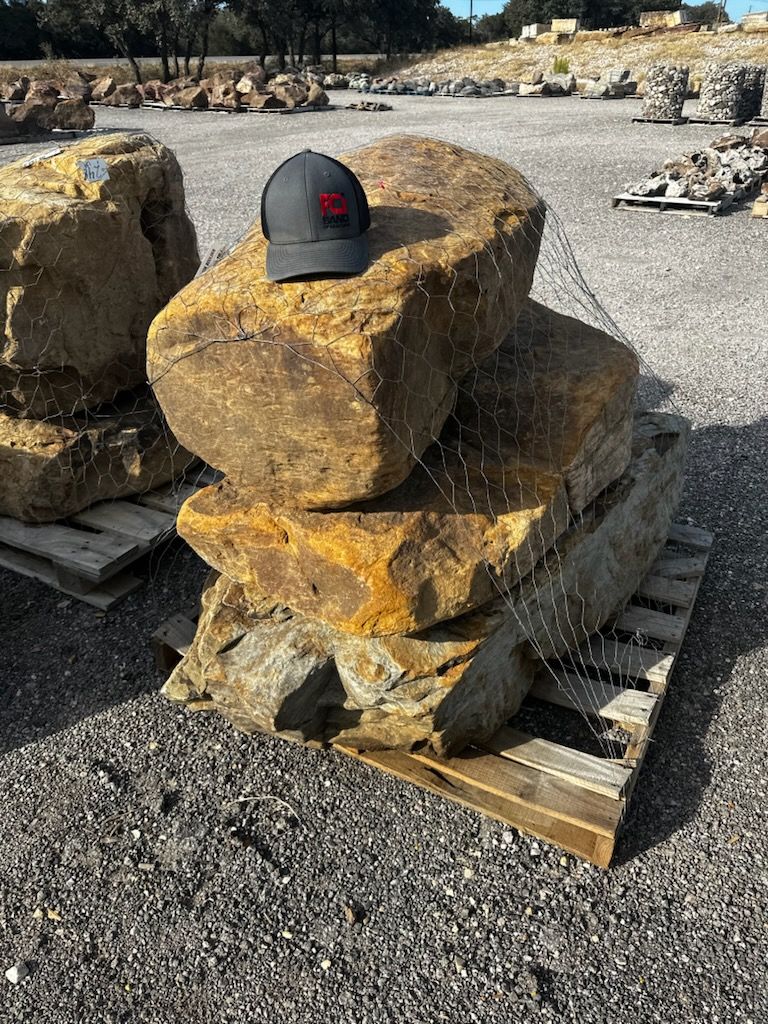A hat is sitting on top of a pile of rocks.