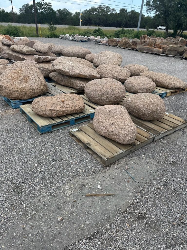 A pile of rocks sitting on top of wooden pallets.