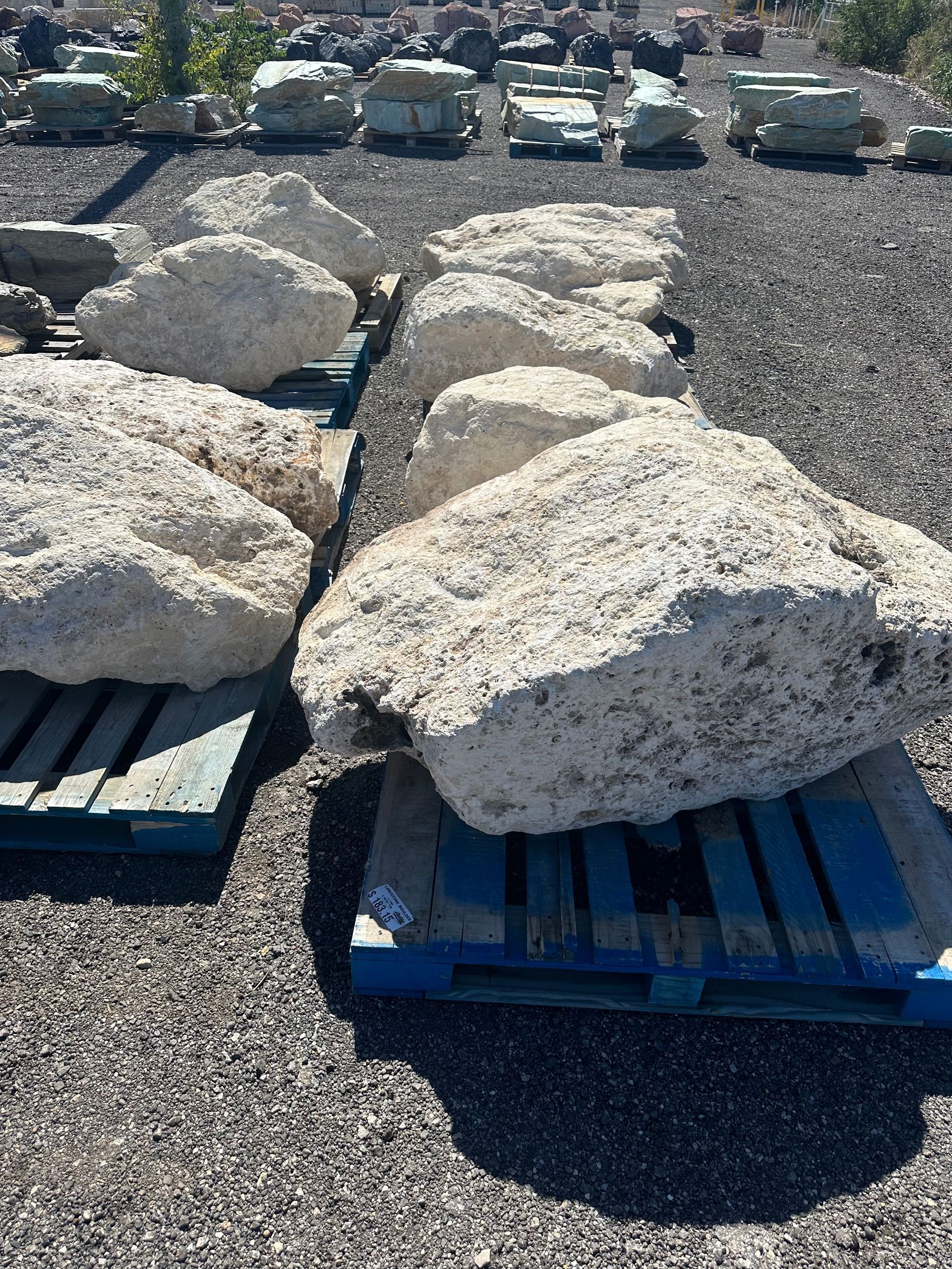 A pile of rocks sitting on top of a blue pallet.