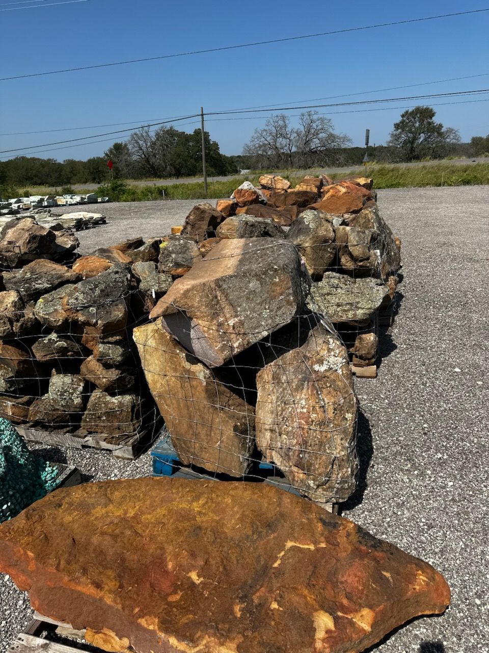 A pile of rocks sitting on top of a pallet on the ground.