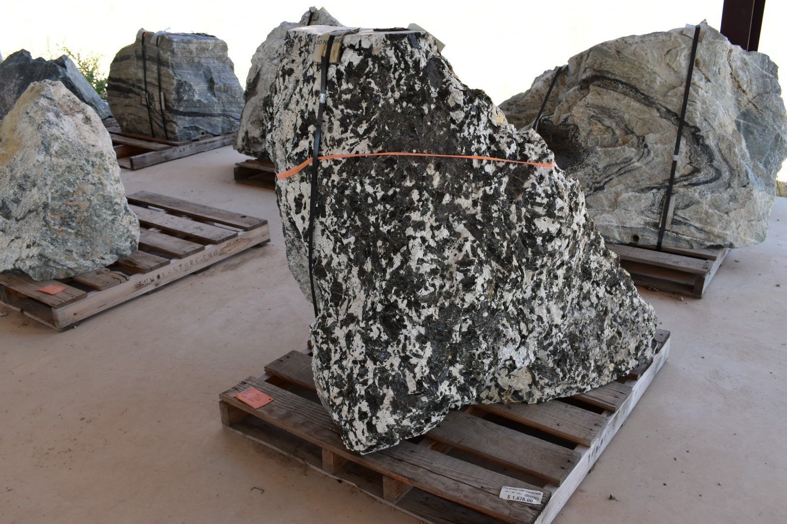 A large rock is sitting on top of a wooden pallet.
