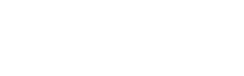 A classic, silver-colored metal compass set against a blurred, dark background.