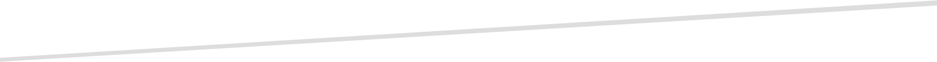 A thin, light gray diagonal line against a white background.