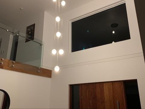 A Living Room With a Staircase and a Large Window — Rob Ward Electrical Services in West Ballina, NSW