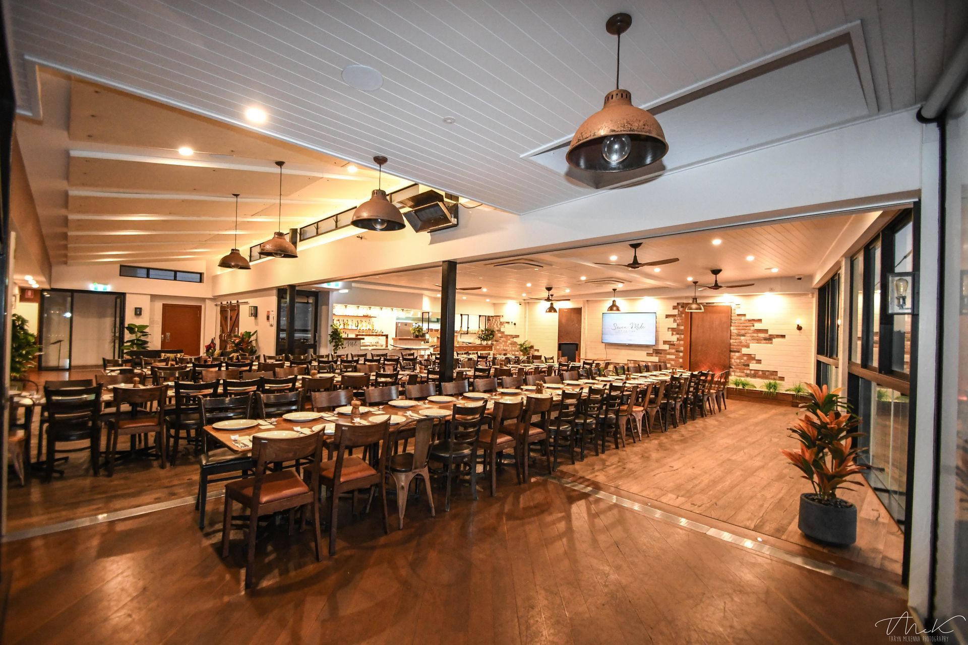 A Spacious, Well-lit Banquet Hall With Long Rows of Wooden Tables — Rob Ward Electrical Services in West Ballina, NSW