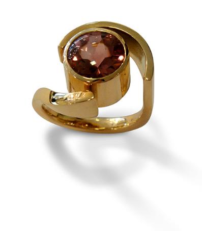 Ein goldener Ring mit einem braunen Stein in der Mitte