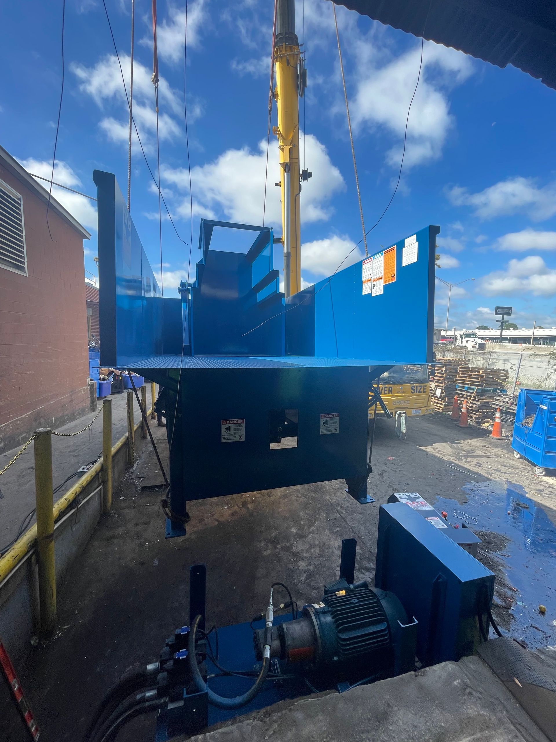 A blue truck with a yellow crane attached to it