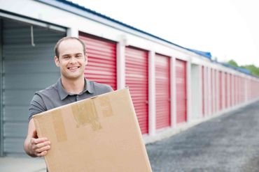 Storage Units — Man Holding a Box in Waterloo, IA