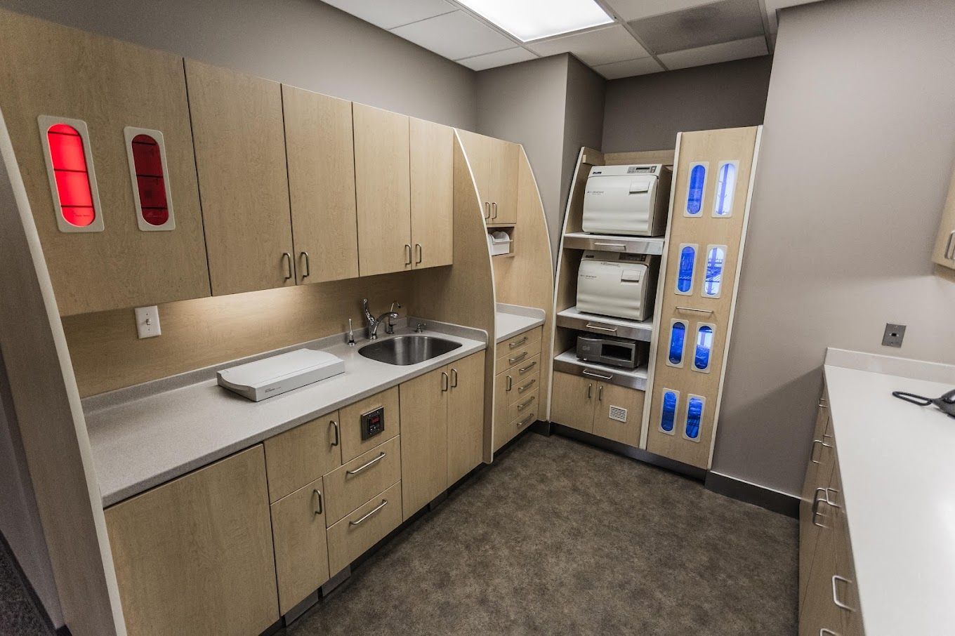 A kitchen with wooden cabinets and a sink.