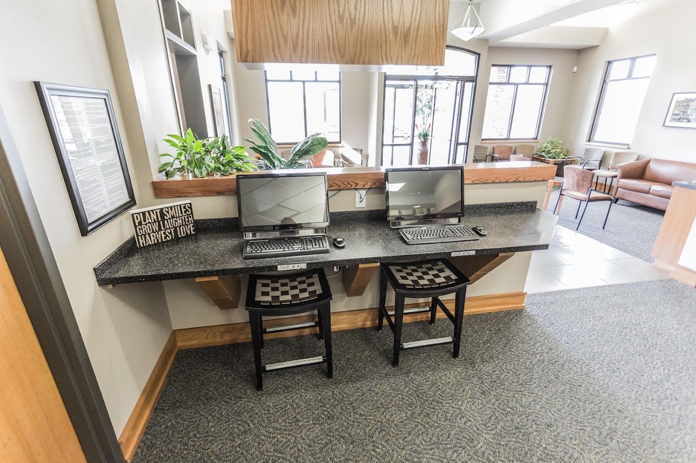 Two computers are sitting on a counter in a room.