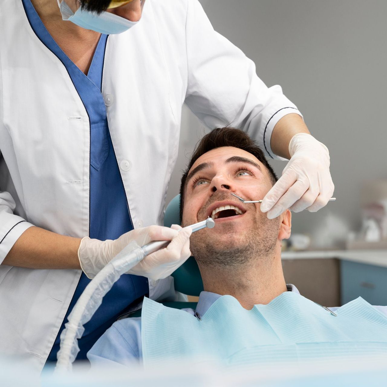 A man is getting his teeth examined by a dentist.