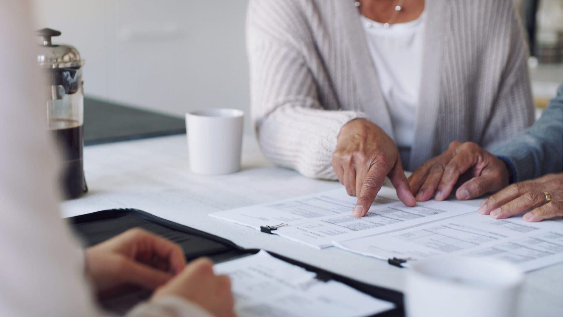 A man and a woman are sitting at a table looking at papers.