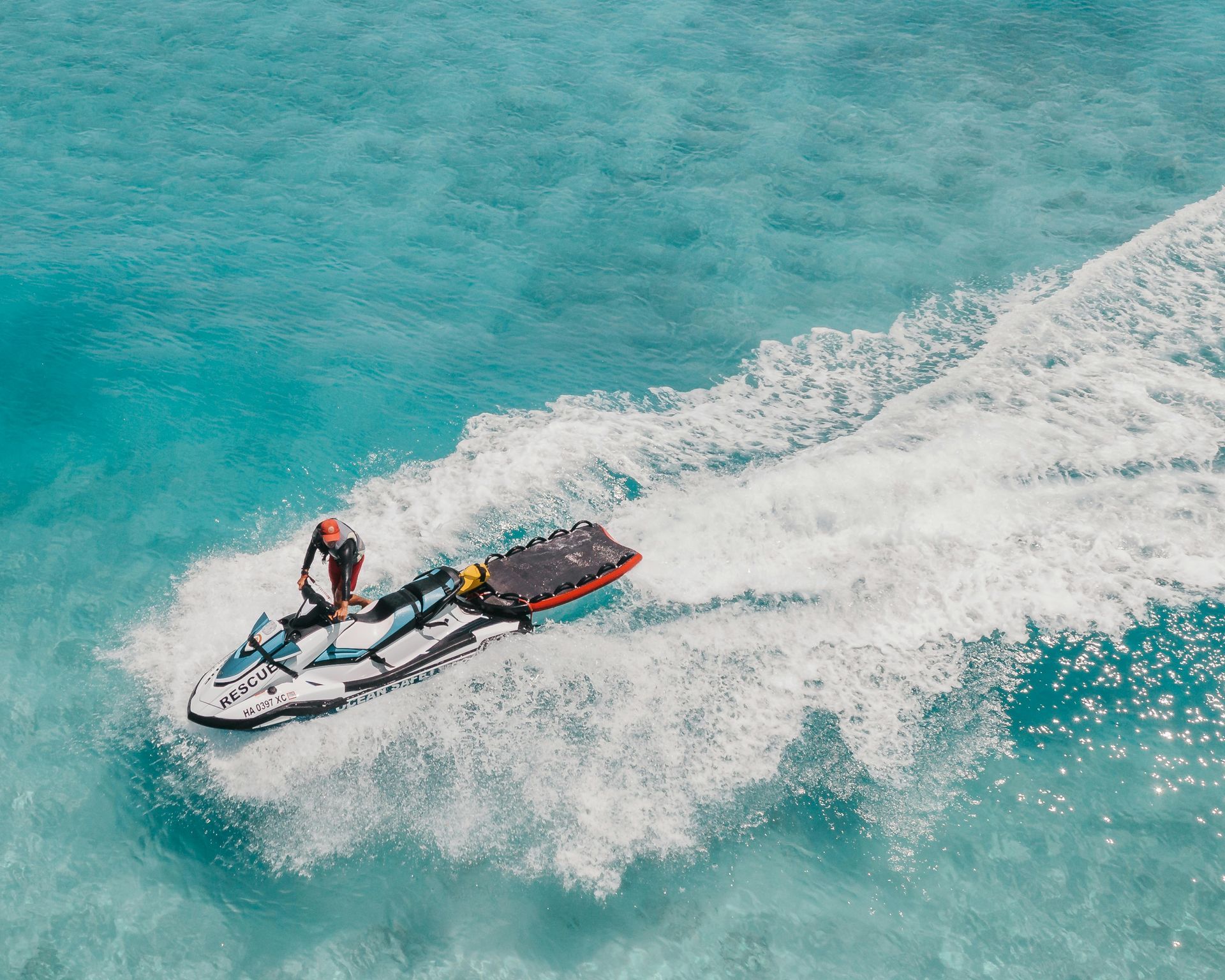 A man is riding a jet ski in the ocean.