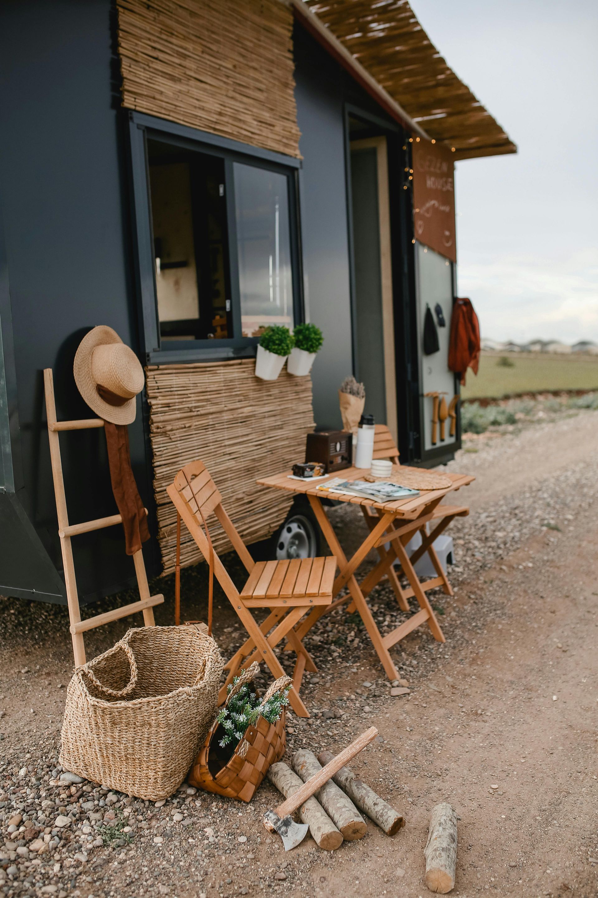 A small house with a table and chairs in front of it.