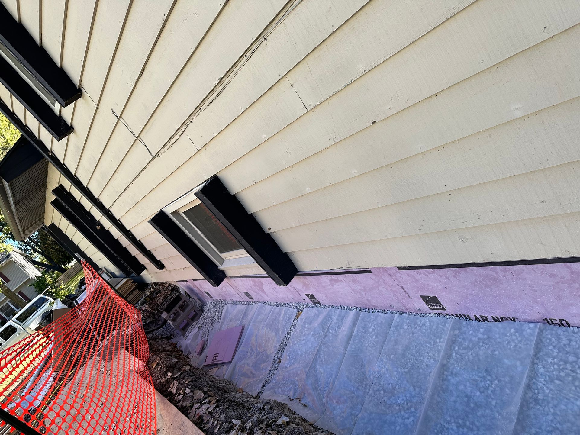 The side of a house with a fence around it