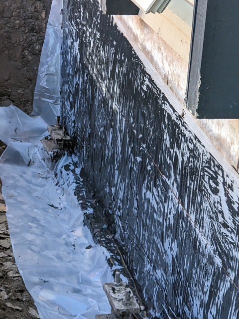 A close up of a wall with black paint on it.