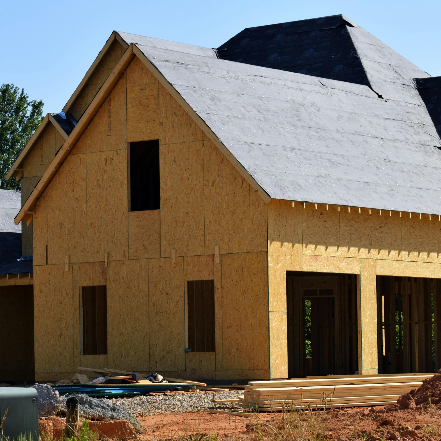 A house under construction with a gray roof