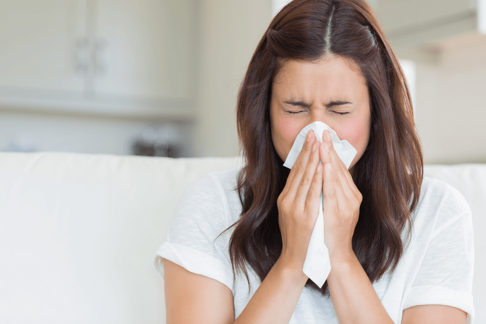Young Woman Suffering Allergy and Blowing Nose with a Tissue — Canberra, Act — Healthy Skin S