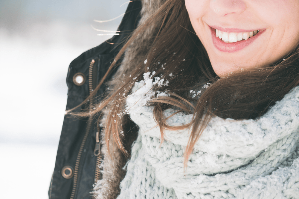Image of a Woman Smiling in Snow Weather — Canberra, Act — Healthy Skin Solutions