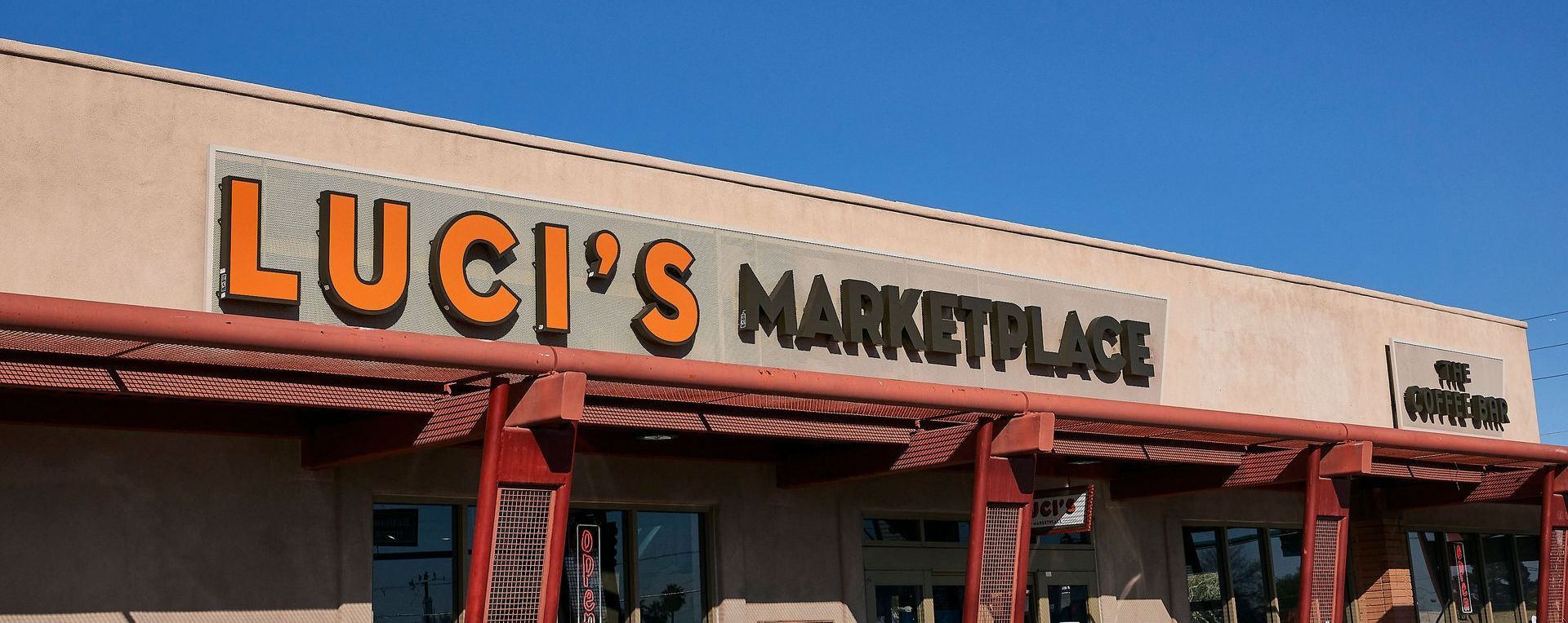 The outside of luci 's market place with a blue sky in the background