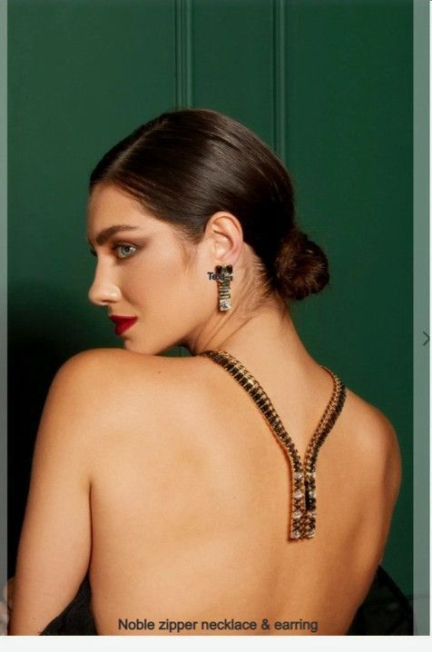 A woman wearing a zipper necklace and earrings.