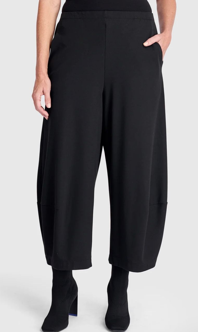 Black cropped, wide-leg pants on a person; side pockets, black ankle boots.