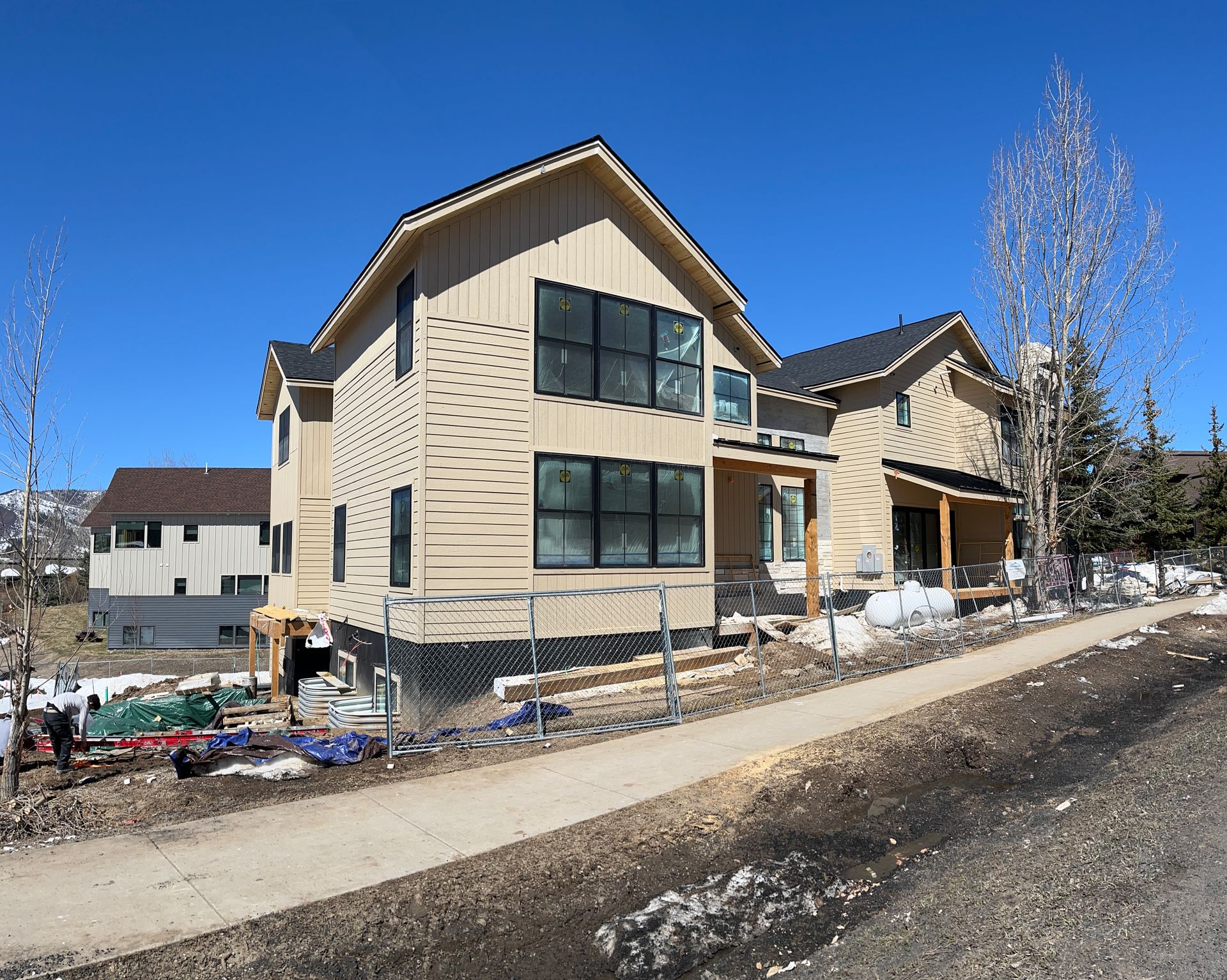 A house that is being built with a lot of windows