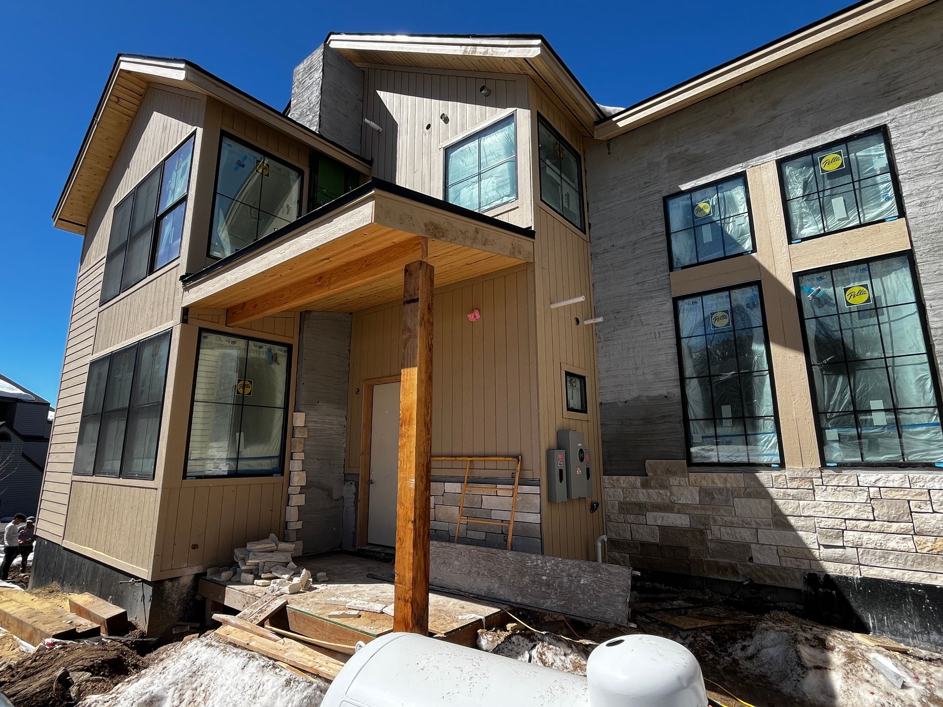 A large house is being built with a lot of windows.