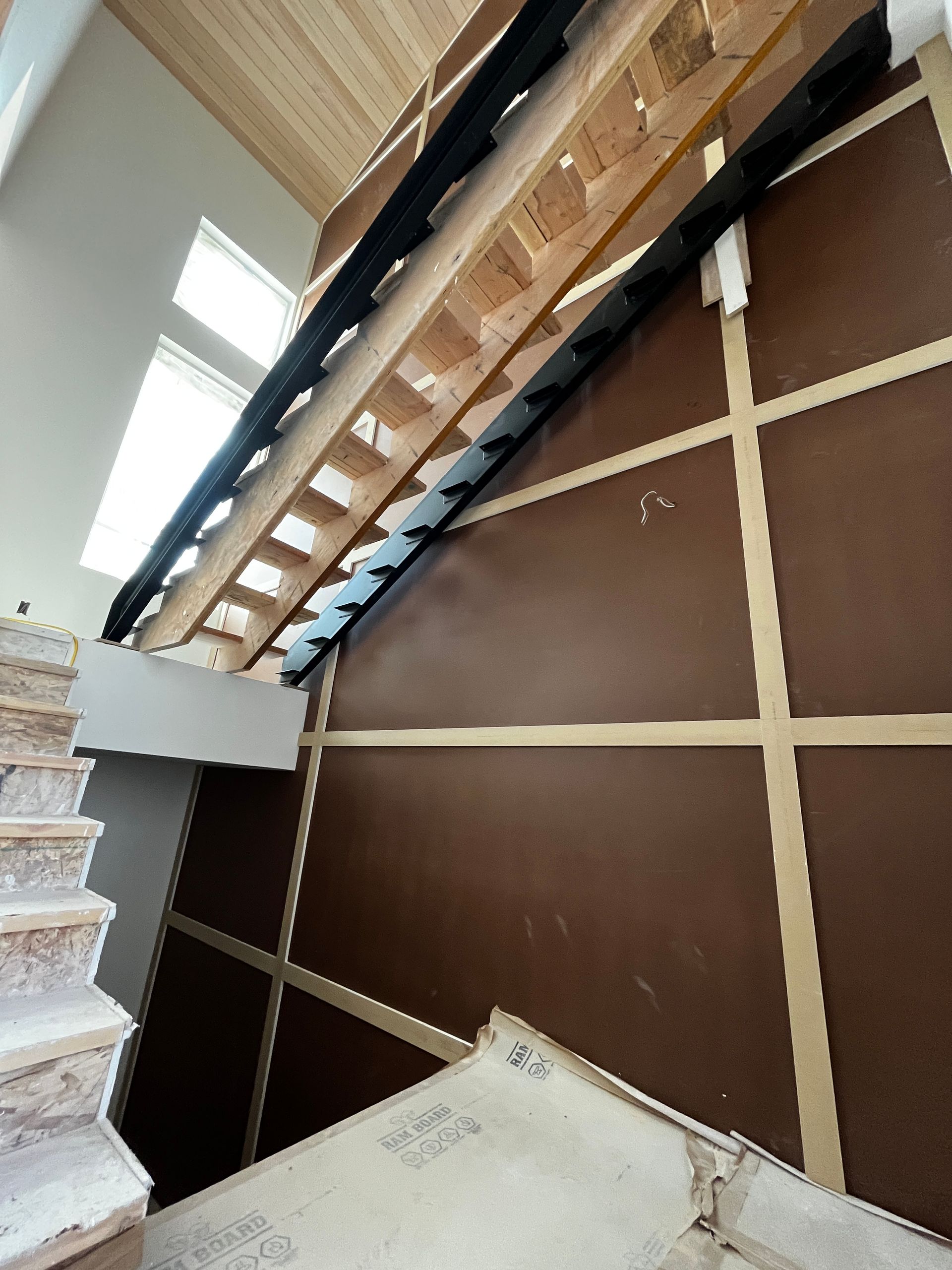 A wooden staircase is being built in a house
