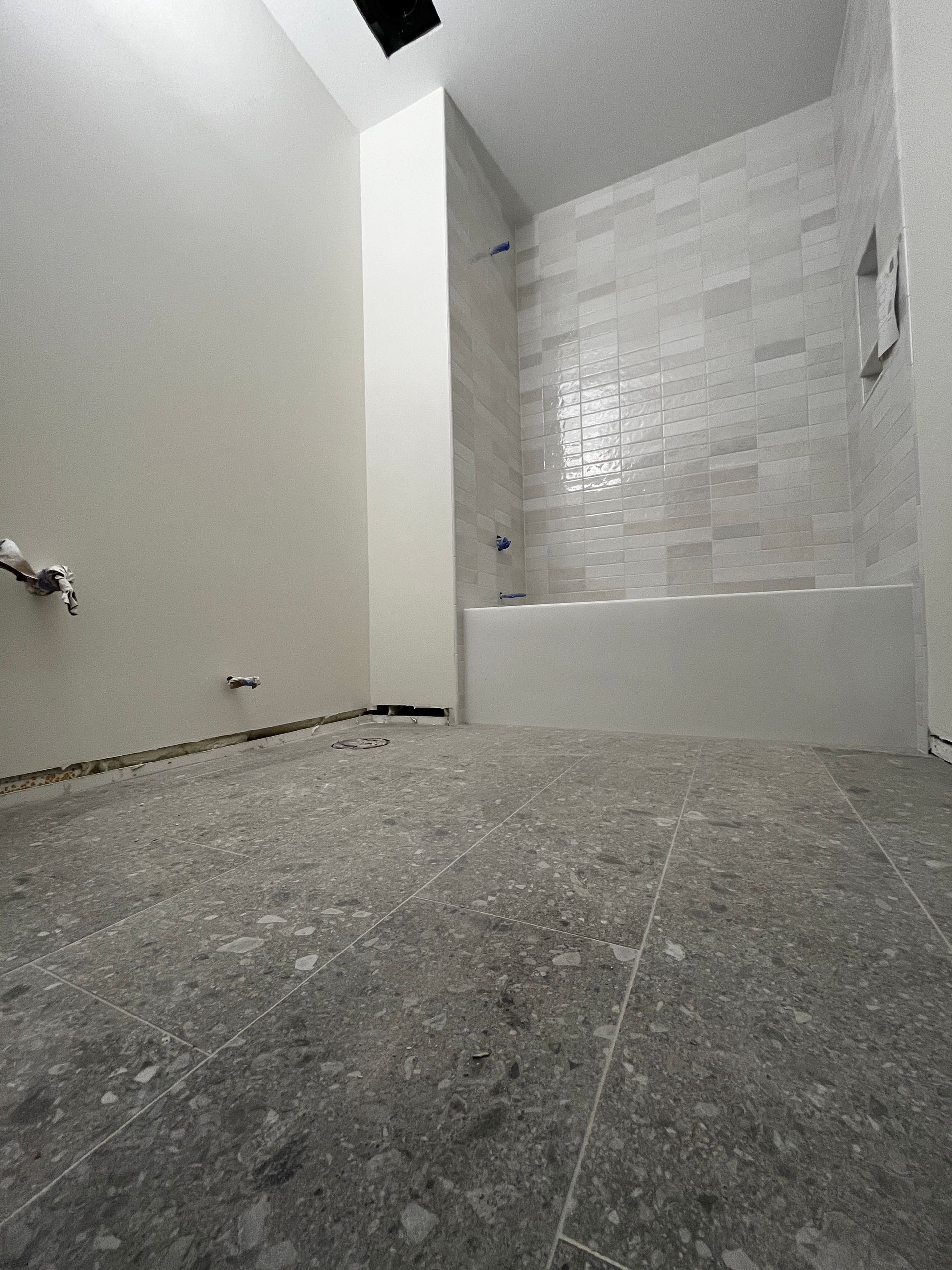 A bathroom under construction with a bathtub and shower.