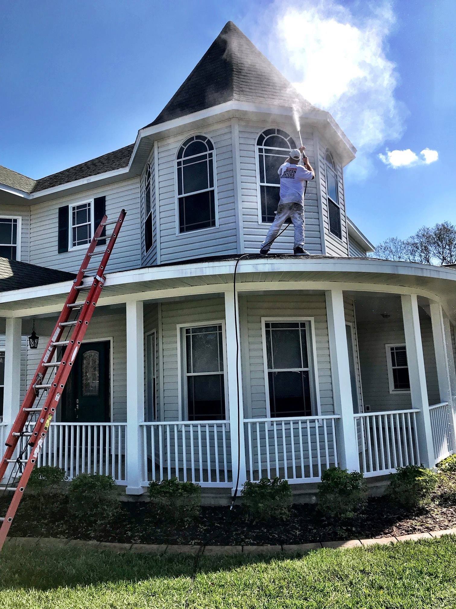 Man Pressure Washing the Exterior of the House — Tampa, FL — American Painters Inc