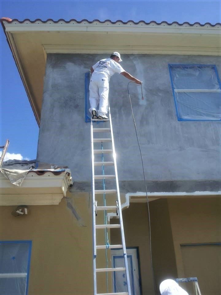 Man Spraying the Exterior of Home — Tampa, FL — American Painters Inc