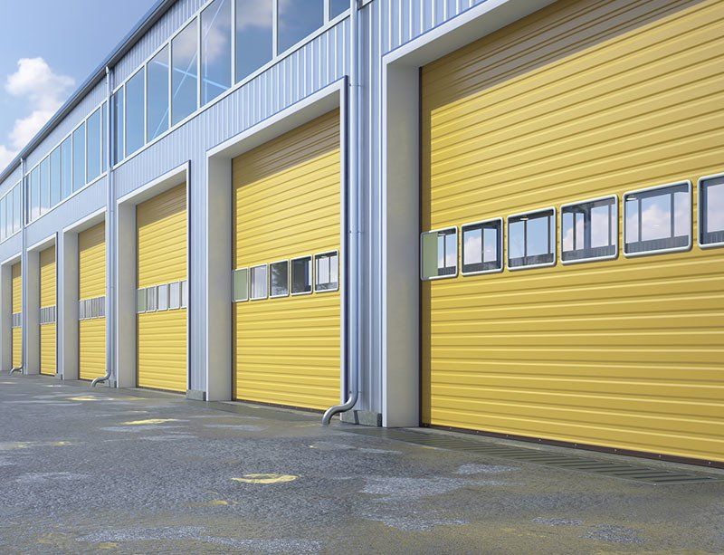 Warehouse with Yellow Rolling Doors — Tampa, FL — American Painters Inc