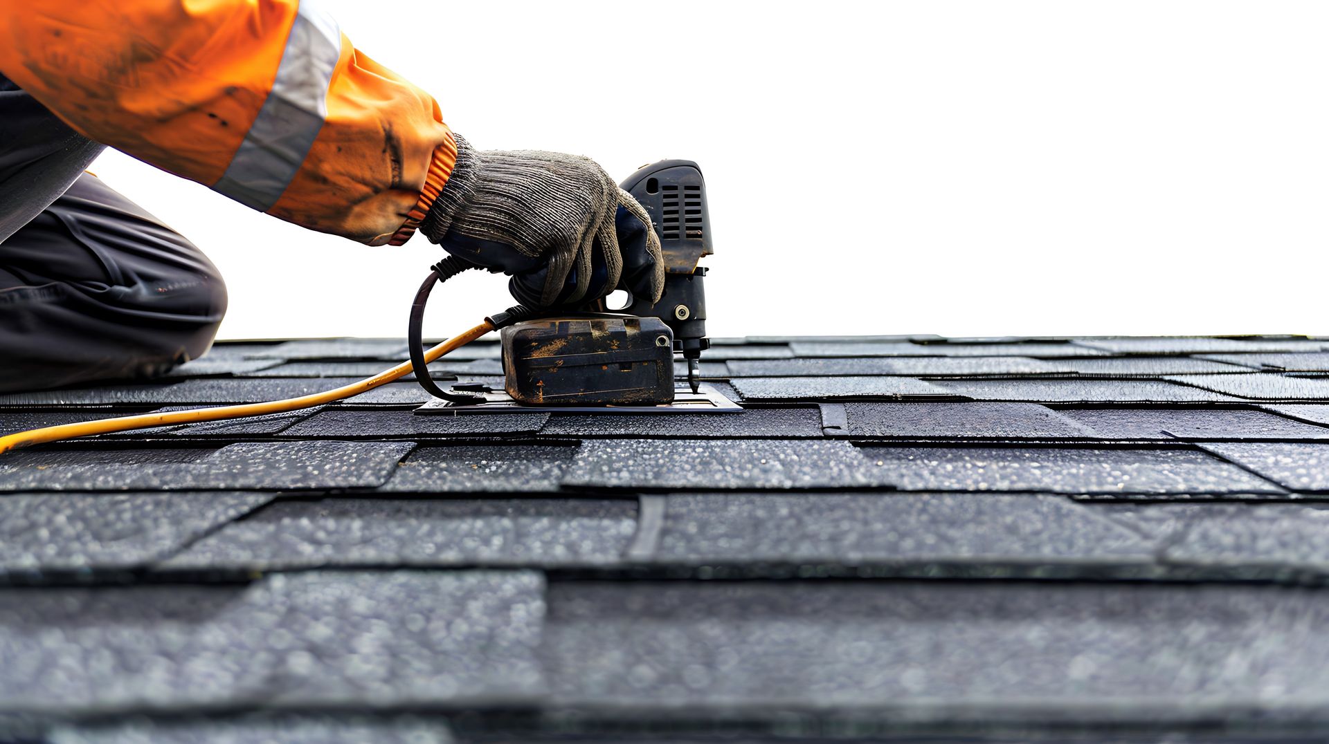 Professional roofing contractor using a pneumatic nail gun to install new asphalt shingles. Professional roofing contractor using a pneumatic nail gun to install new asphalt shingles.