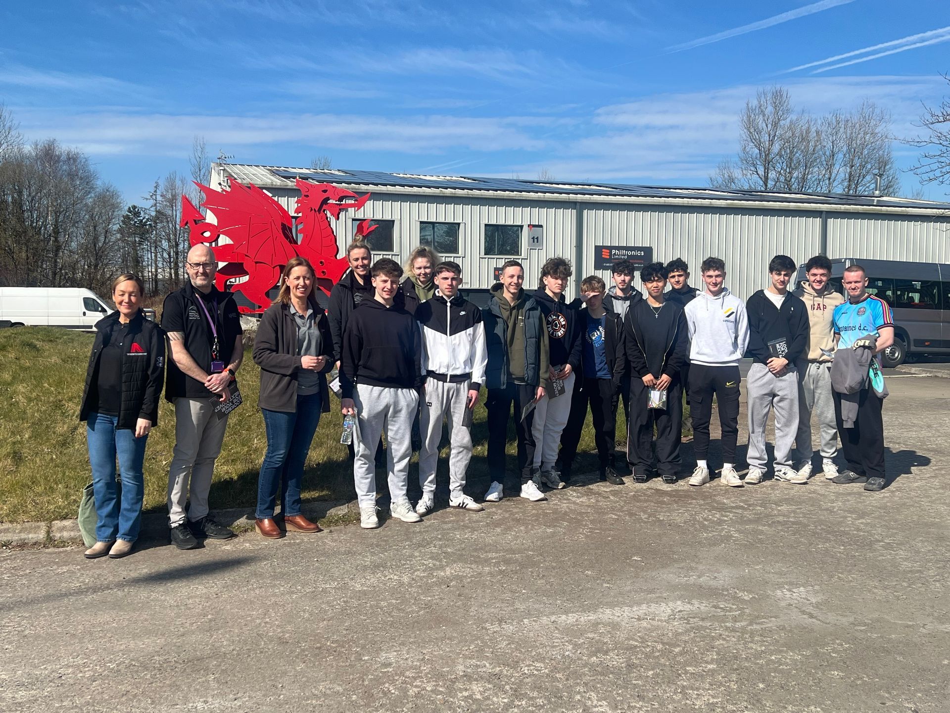 Merthyr College learners and lecturers outside Philtronics HQ with our red dragon. 