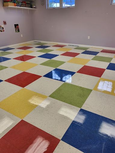 A room with a colorful checkered floor and a window.