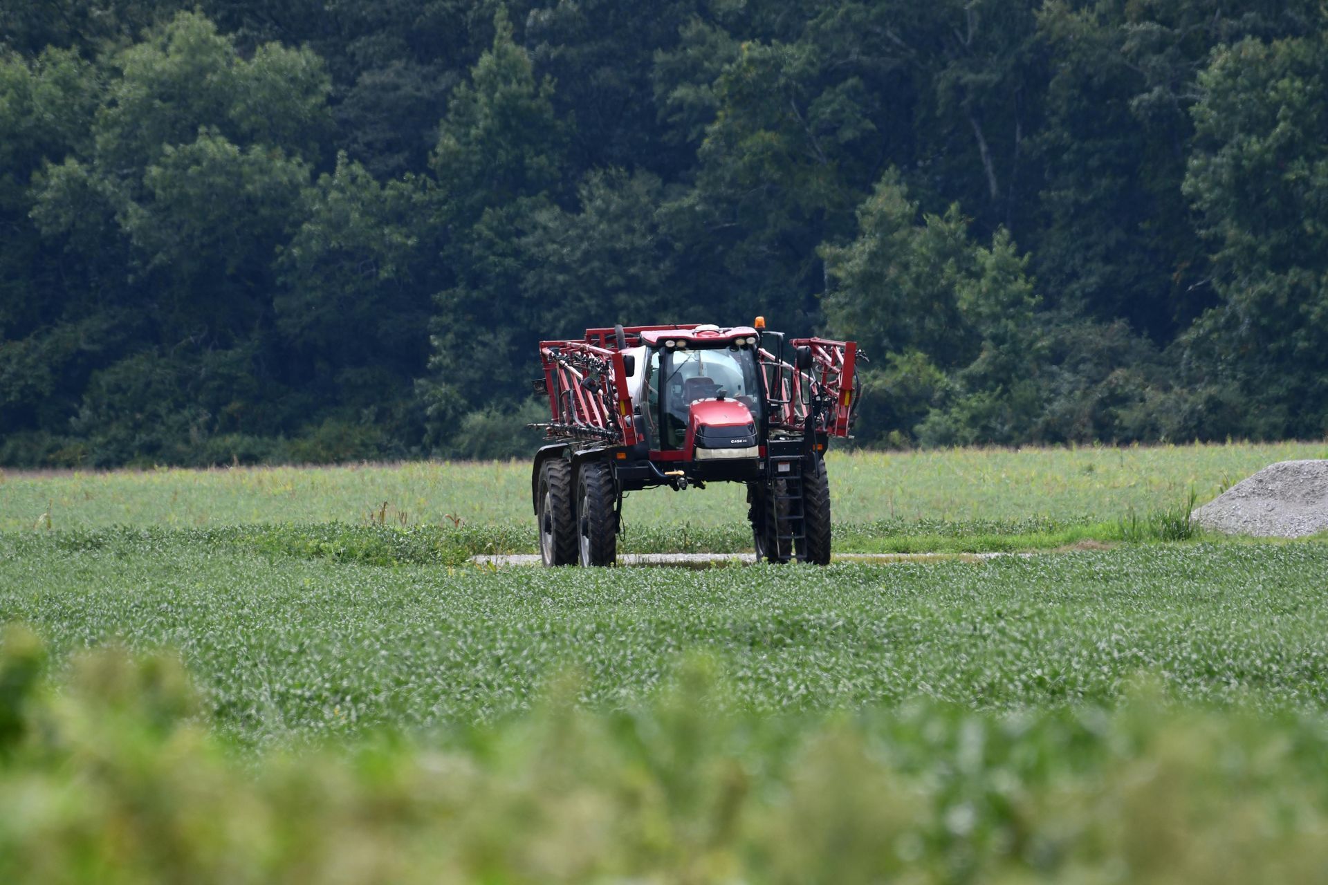 A tractor is spraying fertilizer on a field.