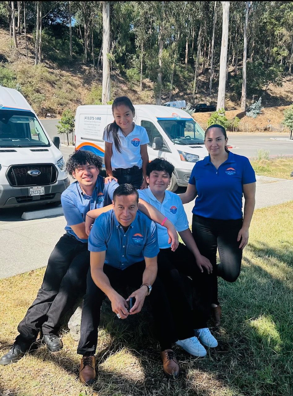 A group of people posing for a picture in front of a van — Novato, CA — Reyes Heating and Air Inc.