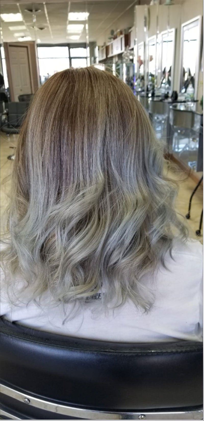 medium length styled hair with light grey highlight