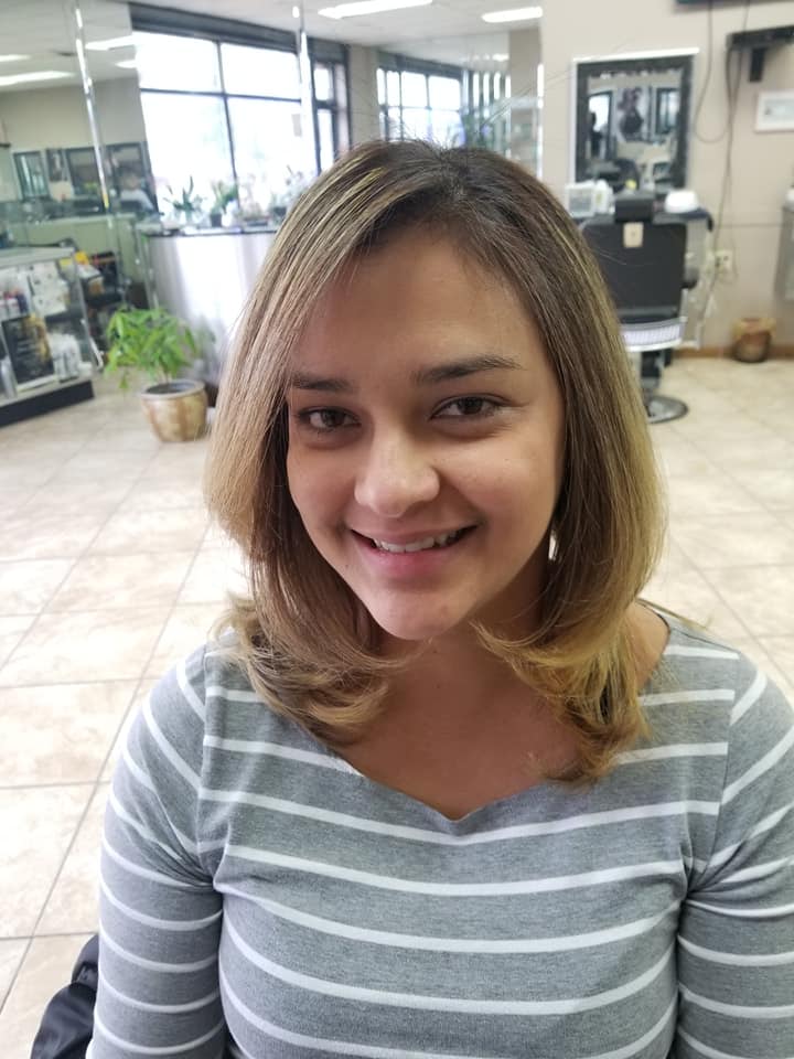 a smiling woman with short blond highlight hair