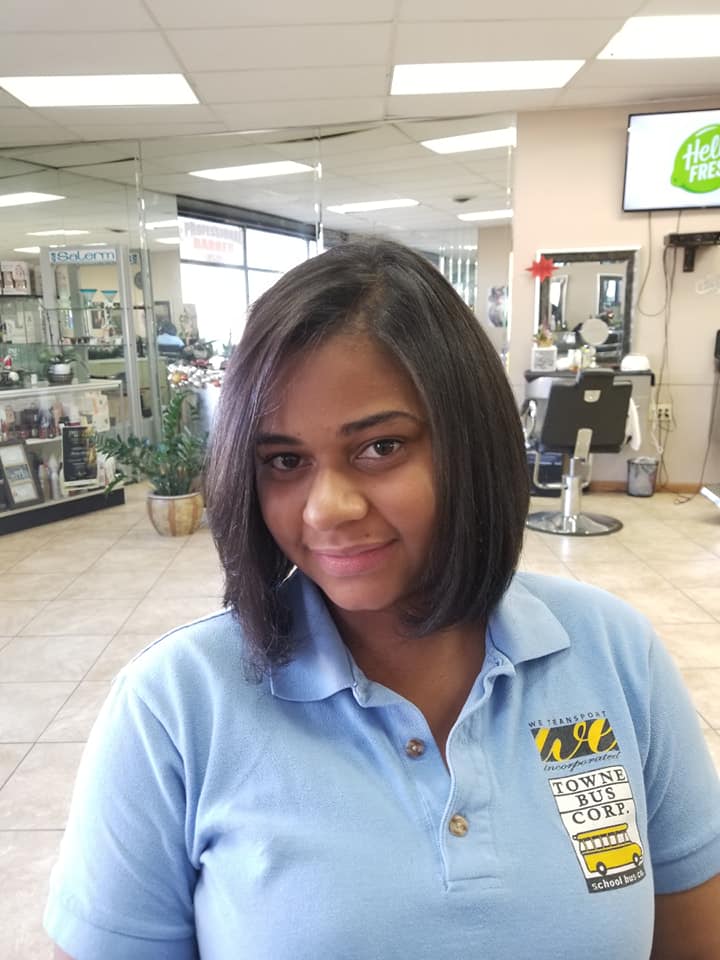 a woman smiling  with her new hair short hair cut